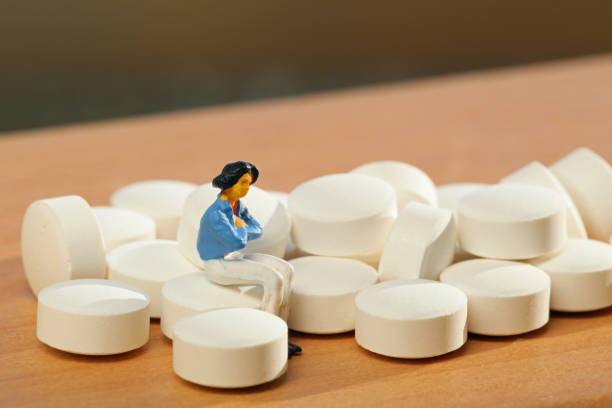 istock Women white tablets and miniature 657558128