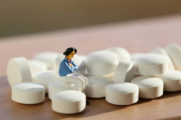 istock Women white tablets and miniature 657558138