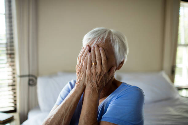 istock Stressed senior woman covering her face with hands 657558580