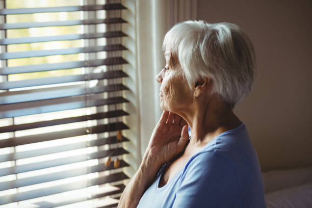 istock Thoughtful senior woman looking out from window 657563016