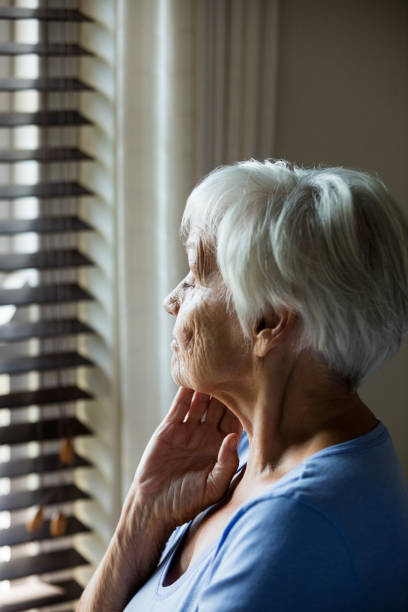 istock Thoughtful senior woman looking out from window 657563122