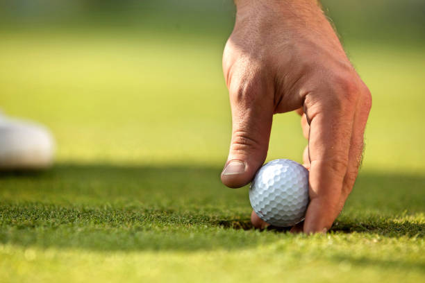 istock Person holding golf ball, close-up 657563564