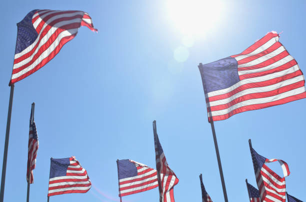 istock American flags in wind rippling on flag poles 657564446