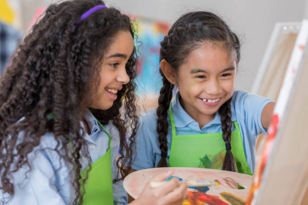 istock Young friends paint together in art class 657565354