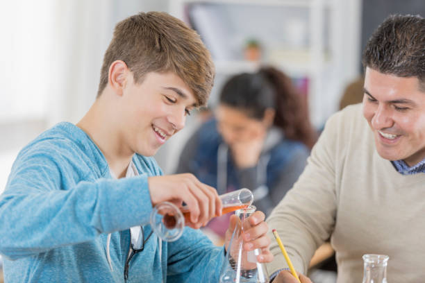 istock Cheerful teenage boy in science lab 657565380