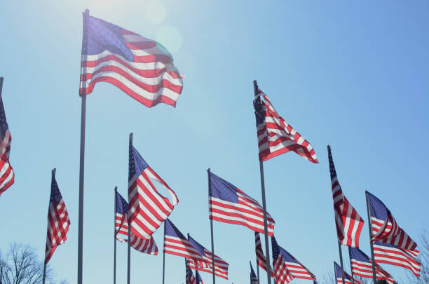 istock American flags in wind rippling on flag poles 657567400