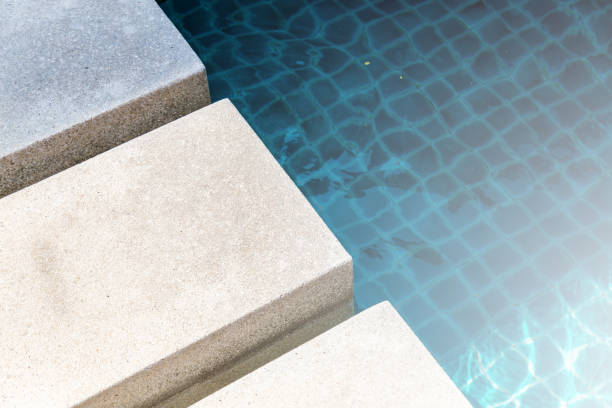 istock light color cement pavement with swimming pool access 657567924