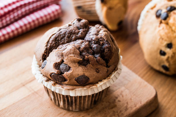 istock Chocolate and Vanilla Muffins on wooden surface. 657568352