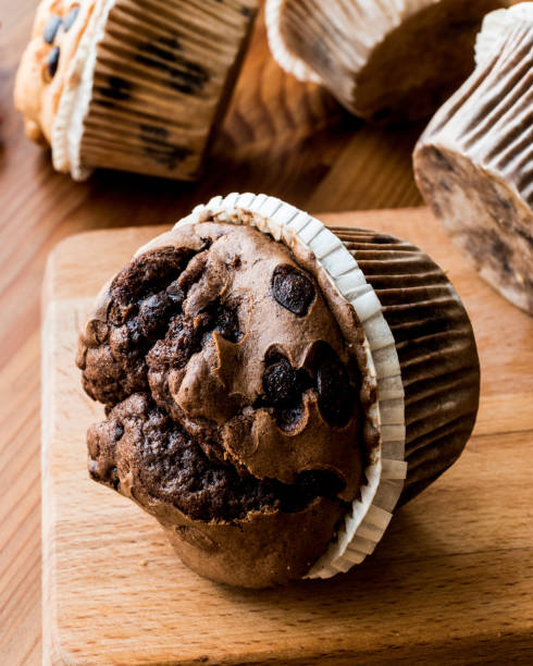 istock Chocolate and Vanilla Muffins on wooden surface. 657568476