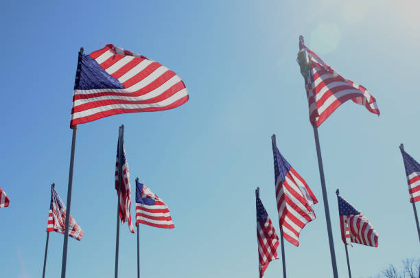 istock American flags in wind rippling on flag poles 657568794
