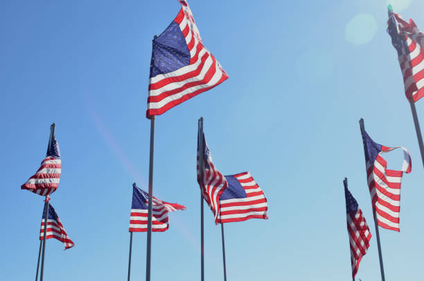 istock American flags in wind rippling on flag poles 657569032