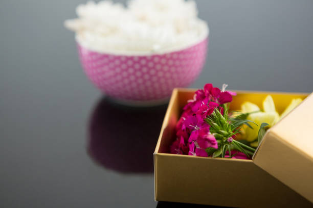 istock Opened gift box and bowl with flowers 657569420