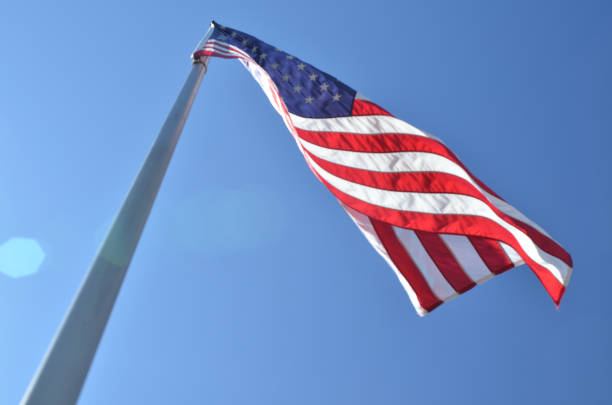 istock American flags in wind rippling on flag poles 657569490