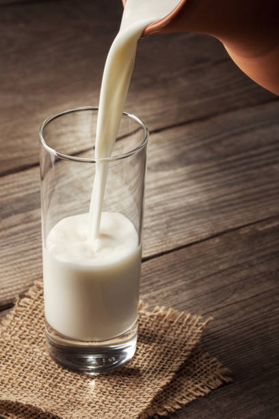 istock jug of milk with an old country table 657570188
