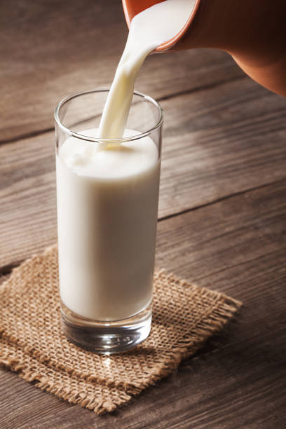 istock jug of milk with an old country table 657570224
