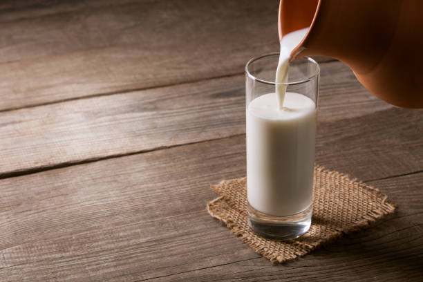 istock jug of milk with an old country table 657570248