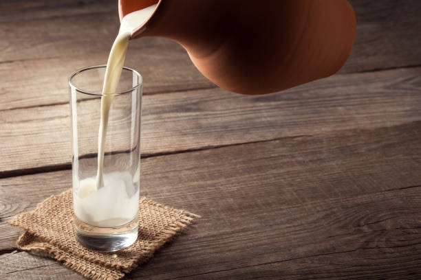 istock jug of milk with an old country table 657570280