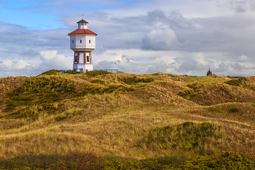 A lighthouse and water tower at the island of Langeoog, East Frisian islands, Lower Saxony, Germany