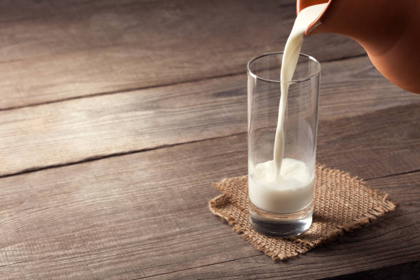 istock jug of milk with an old country table 657570768