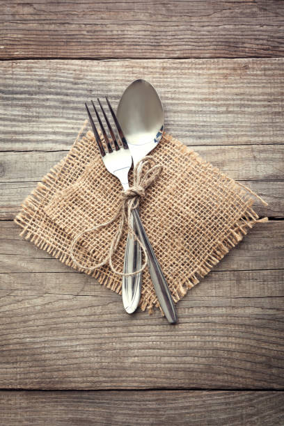 istock Old fork and spoon on a wooden table napkin and burlap 657570990