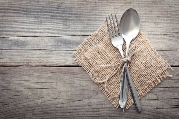istock Old fork and spoon on a wooden table napkin and burlap 657571002