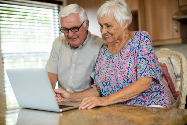 istock Senior couple using laptop in the kitchen 657571750