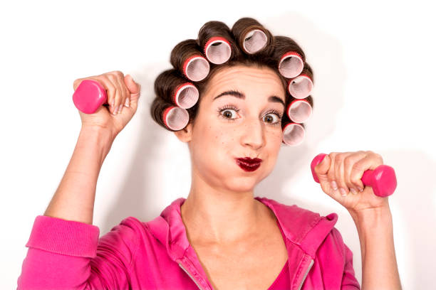 istock pretty young model plays with pink dumbbells 657572434