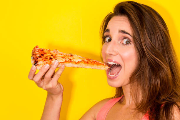 istock happy girl eating pizza 657572710