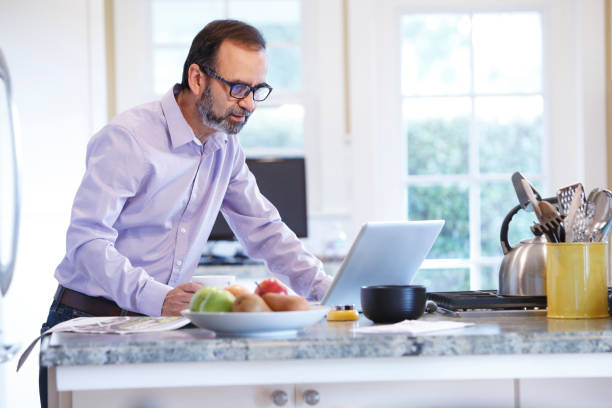 istock Latino Businessman Working From Home At His Kitchen Counter 657573174