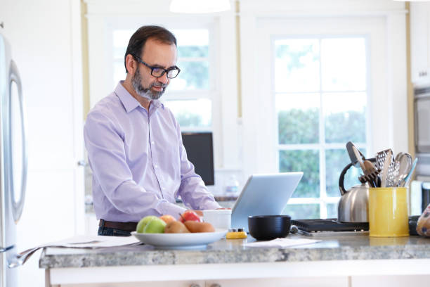 istock Latino Businessman Working From Home At His Kitchen Counter 657573348