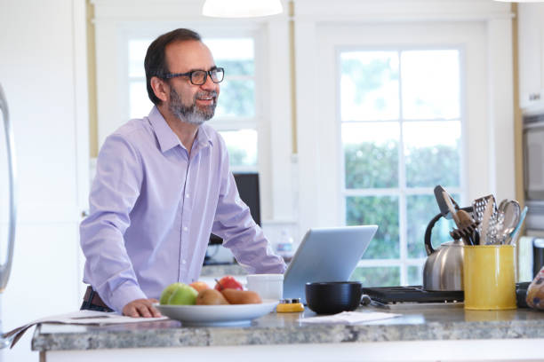 istock Latino Businessman Working From Home At His Kitchen Counter 657573356
