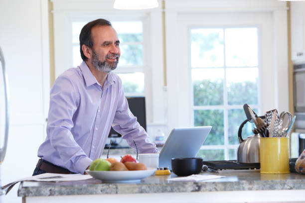 istock Latino Businessman Working From Home At His Kitchen Counter 657573470