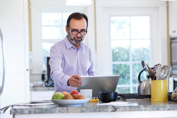 istock Latino Businessman Working From Home At His Kitchen Counter 657573480