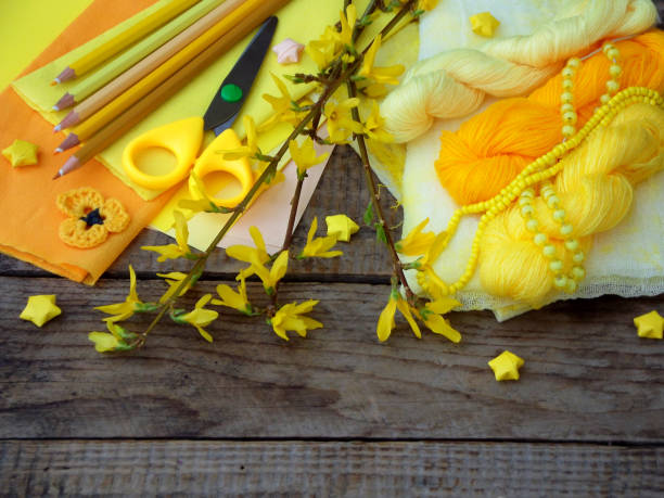 istock Composition of yellow accessories for hobby on grey wooden background. Knitting, needlework, sewing, painting, origami. Small business. Income from hobby. 657573628