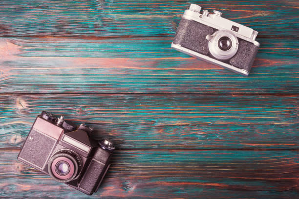 istock Retro cameras over old wooden background 657573640