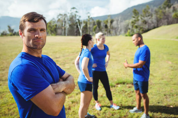 istock Fit man standing with arms crossed in boot camp 657574832