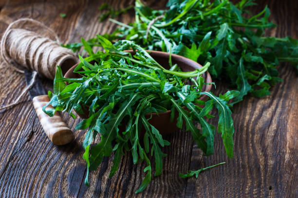 istock Bunch of fresh organic arugula in ceramic bowl 657592908