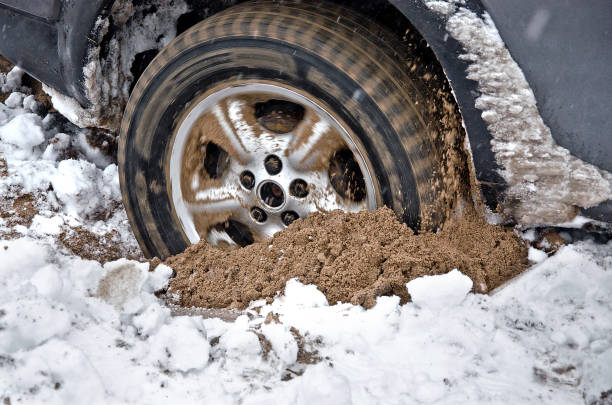 car wheel is deeply stuck in the sand