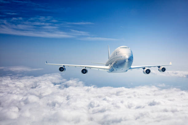 istock commercial airplane flying over the clouds 657595408