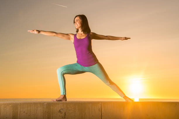 istock Young Women Doing Yoga At Sunset 657595422