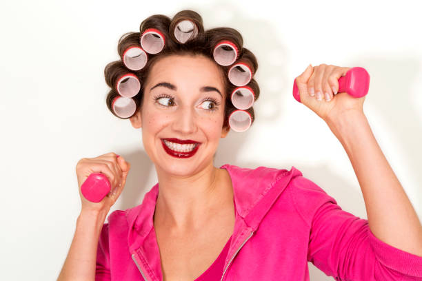 istock pretty young model plays with pink dumbbells 657596326