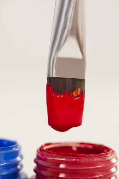 istock Paint brush dipped into red color against white background 657599100