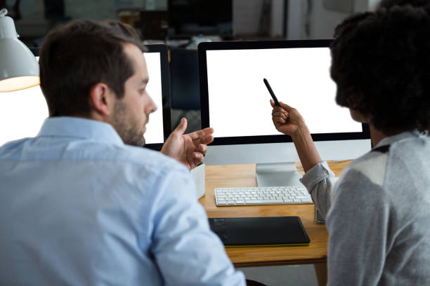 istock Man and woman discussing over desktop pc 657599390