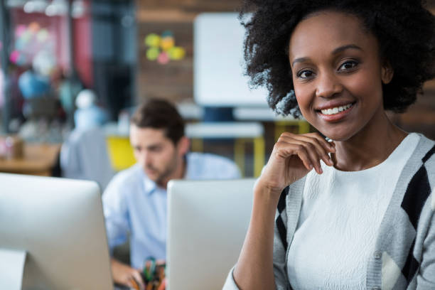 istock Happy woman standing in office 657599516