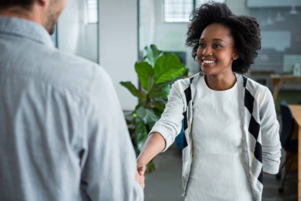 istock Happy woman shaking hands with colleague 657599622