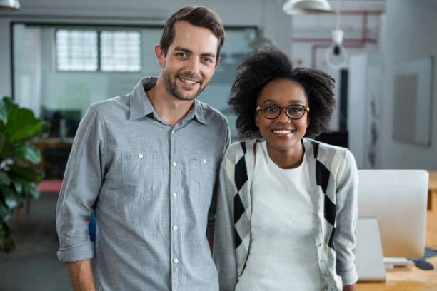 istock Happy man and woman standing in office 657599670