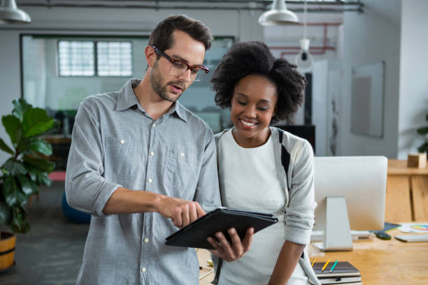 istock Man and woman discussing over digital laptop 657599698