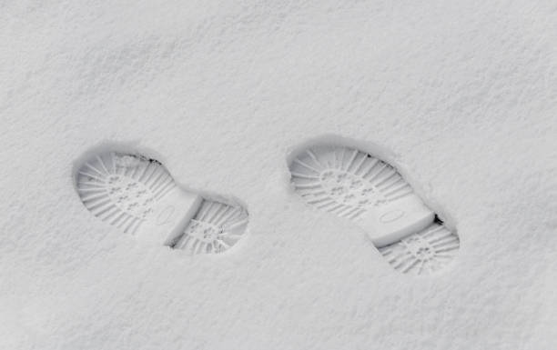 istock Footsteps in the snow, boot mark close up outdoor 657605884