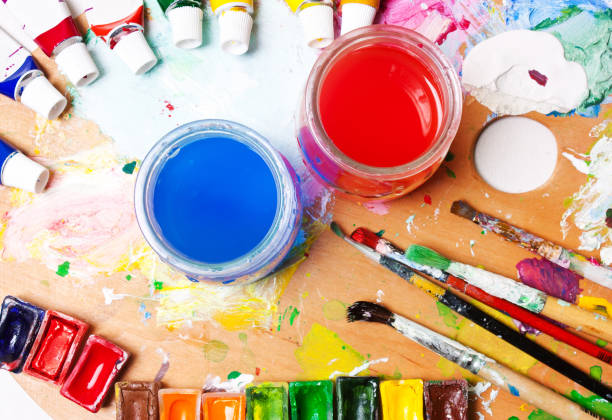 istock Multicolored paints, brushes, palette, water. Desk, workplace artist. . Drawing concept.backgrounds art 657606550