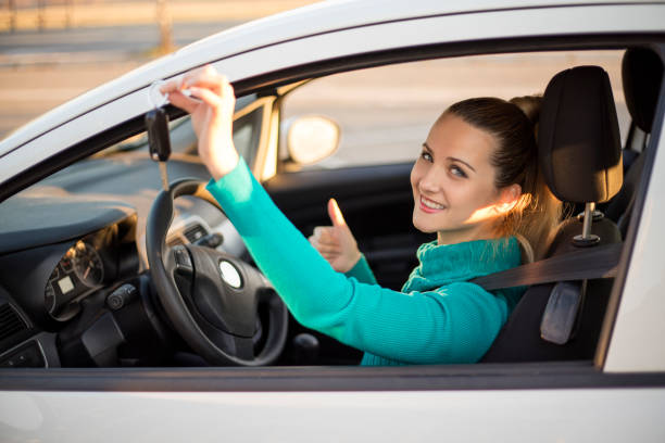 istock Happy woman in her car 657609130